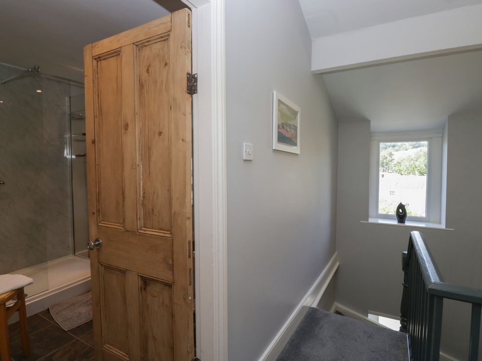 A hallway with a door leading to a shower at Number Thirty-Nine in Ulverston