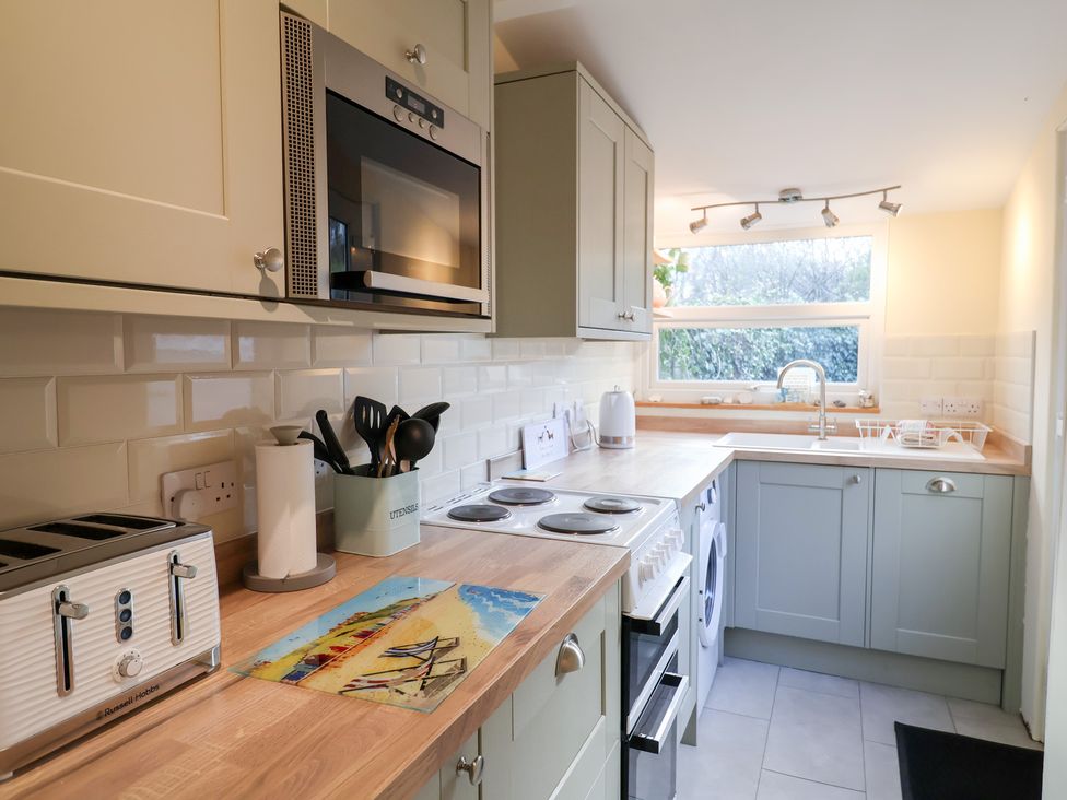 A kitchen with appliances and utensils at Cobbler's Cottage Mundesley