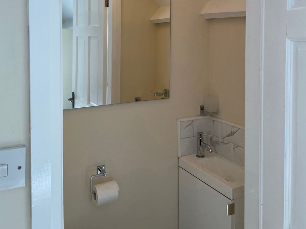 A bathroom with a sink and a mirror at Willow Nook in Glaisdale near Lealholm
