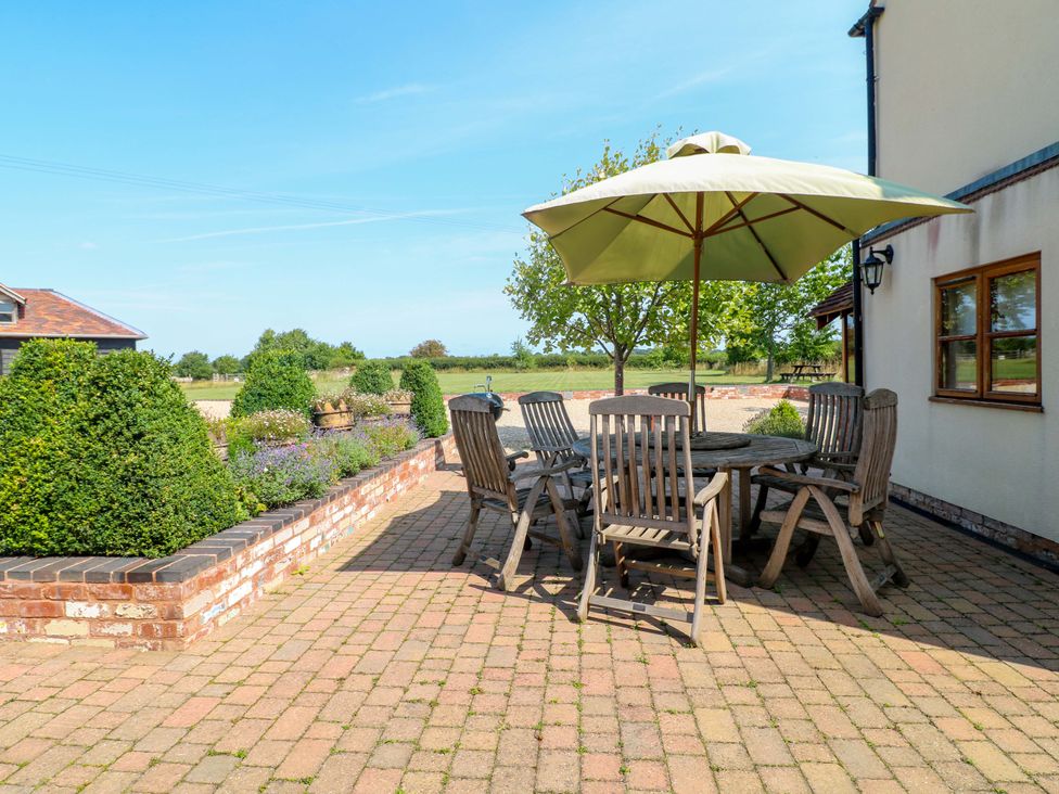 An outdoor seating area with table and chairs at Bellamour End Cottage Rugeley