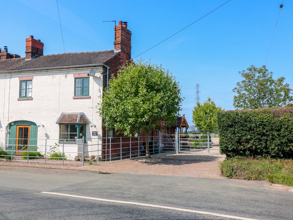 A house with a fence and gate at Bellamour End Cottage Rugeley