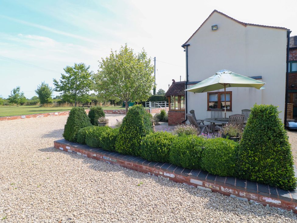 An outdoor area with plants and seating at Bellamour End Cottage Rugeley