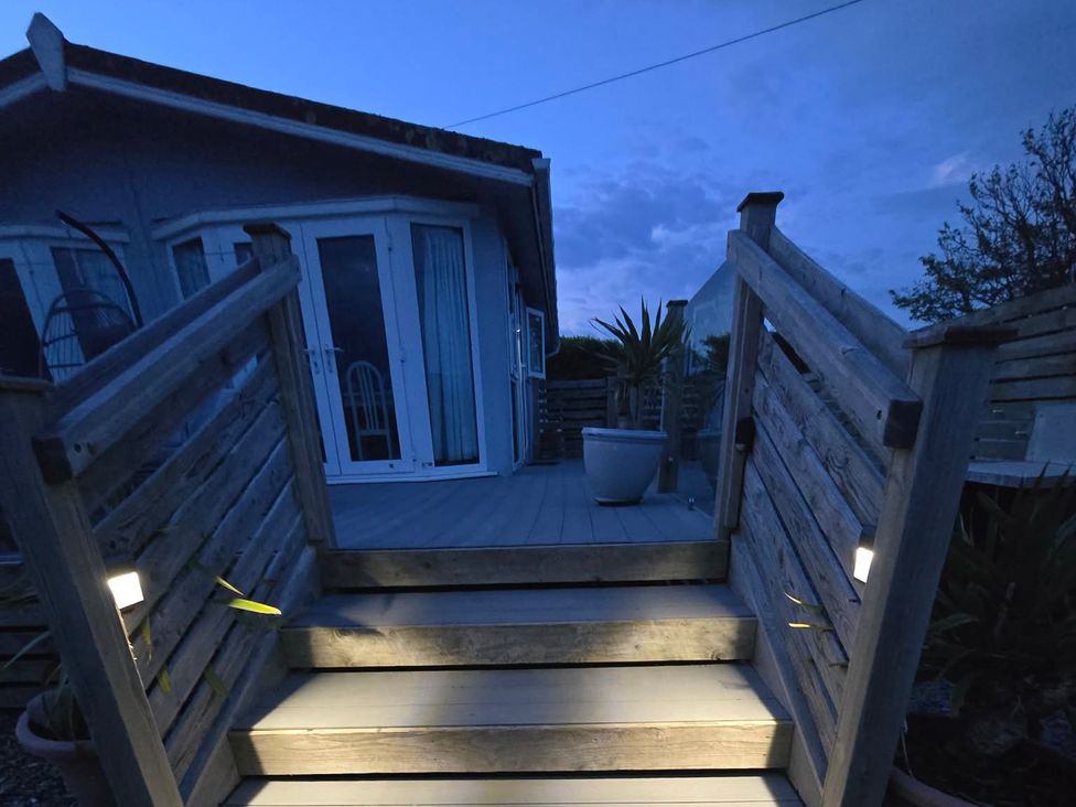 An outdoor area with stairs leading to a house at Caban Tywod in Abersoch
