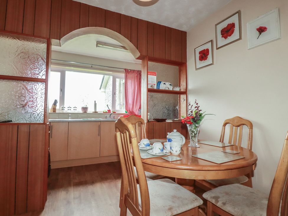 A kitchen with a table and chairs at Underlanes in Boscastle