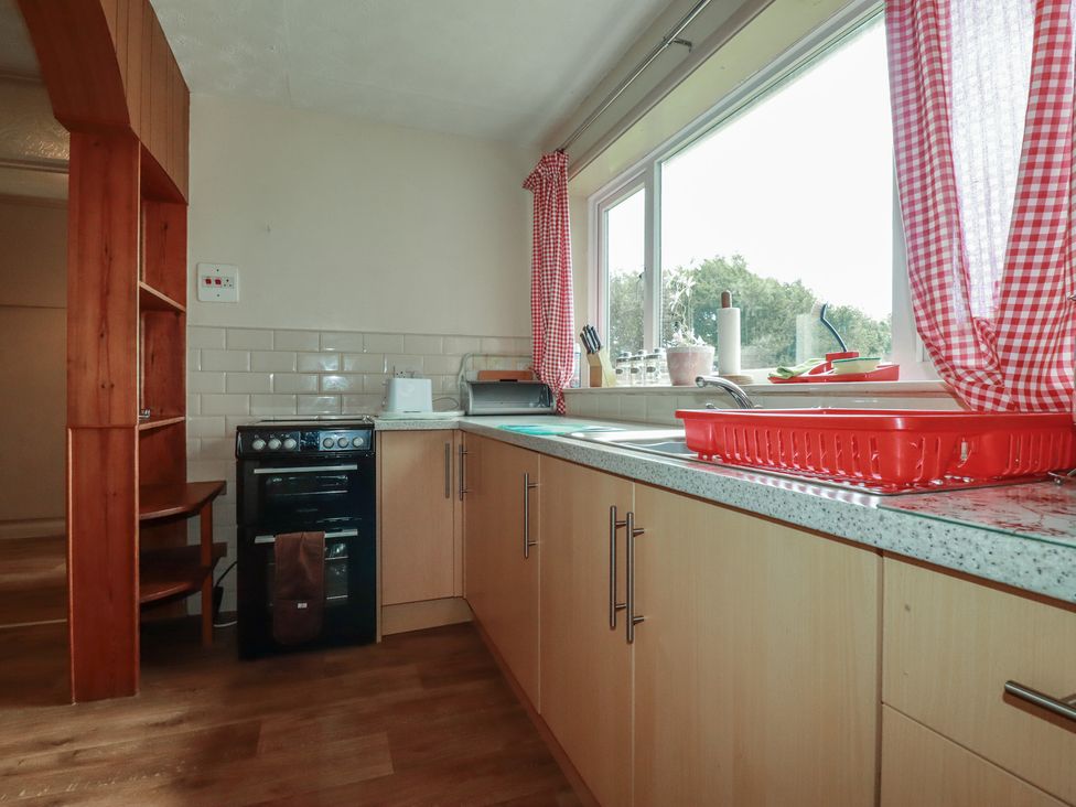 A kitchen with a stove and sink at Underlanes in Boscastle