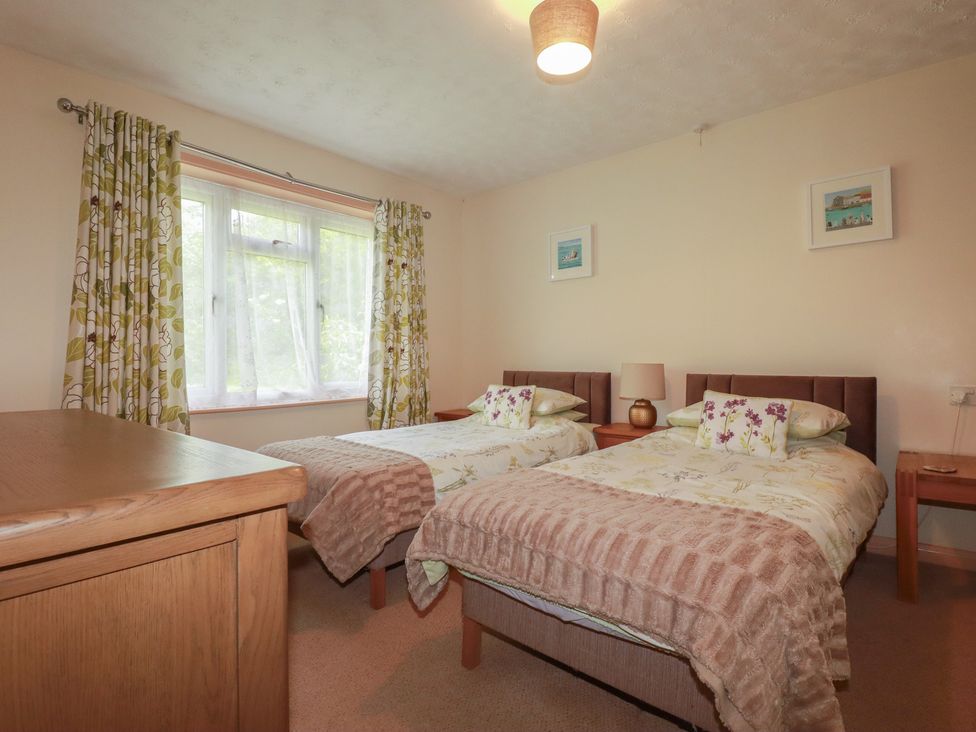 A bedroom with two beds and a window at Underlanes in Boscastle