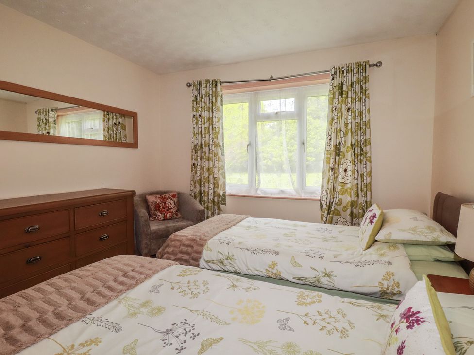 A bedroom with two beds and a dresser at Underlanes in Boscastle