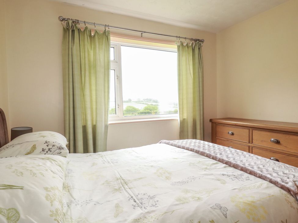 A bedroom with a bed and window at Underlanes in Boscastle