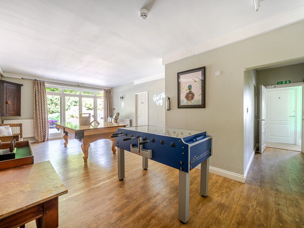 A game room with a foosball table and pool table at Milton Manor in Milton On Stour
