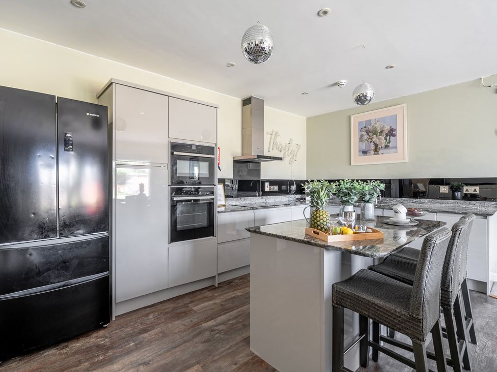 A kitchen with refrigerator, oven and kitchen island at Milton Manor Milton On Stour