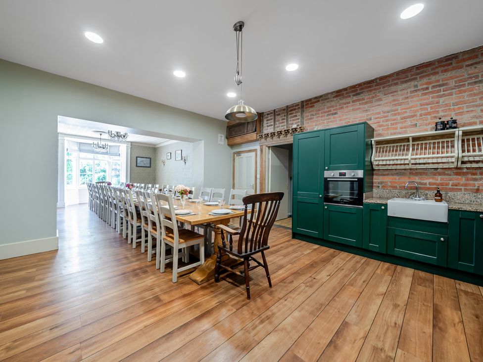 A kitchen with a dining table and chairs at Milton Manor in Milton On Stour