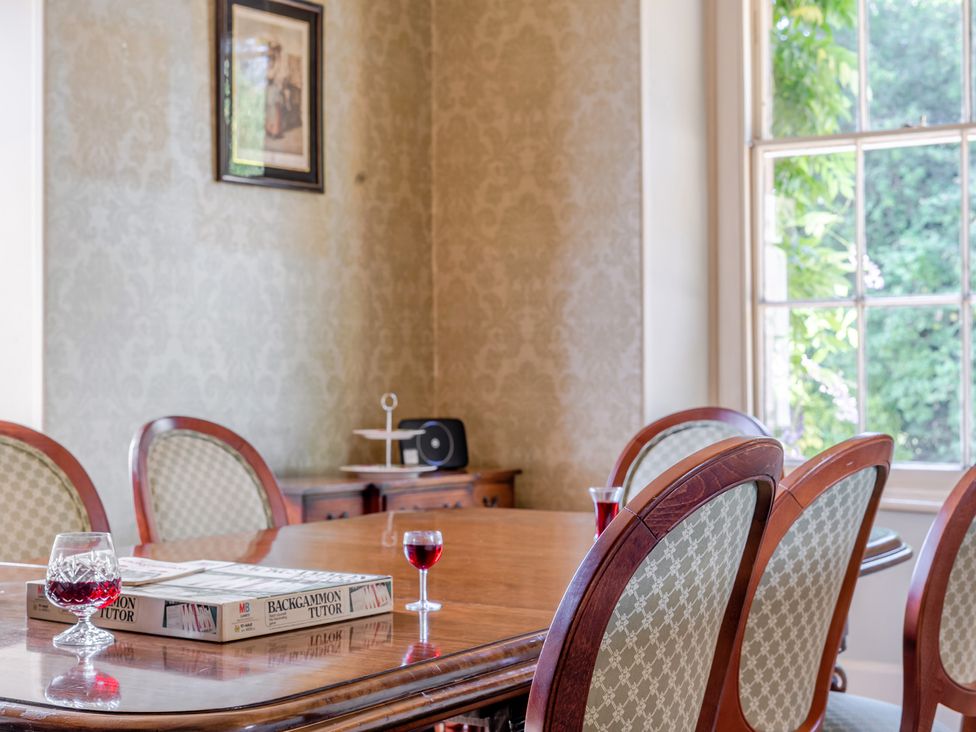 A dining room with a table and chairs at Milton Manor in Milton On Stour