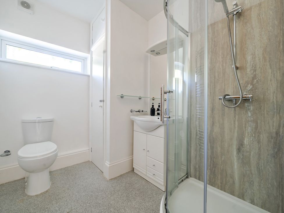 A bathroom with a toilet, sink, and shower at Milton Manor in Milton On Stour