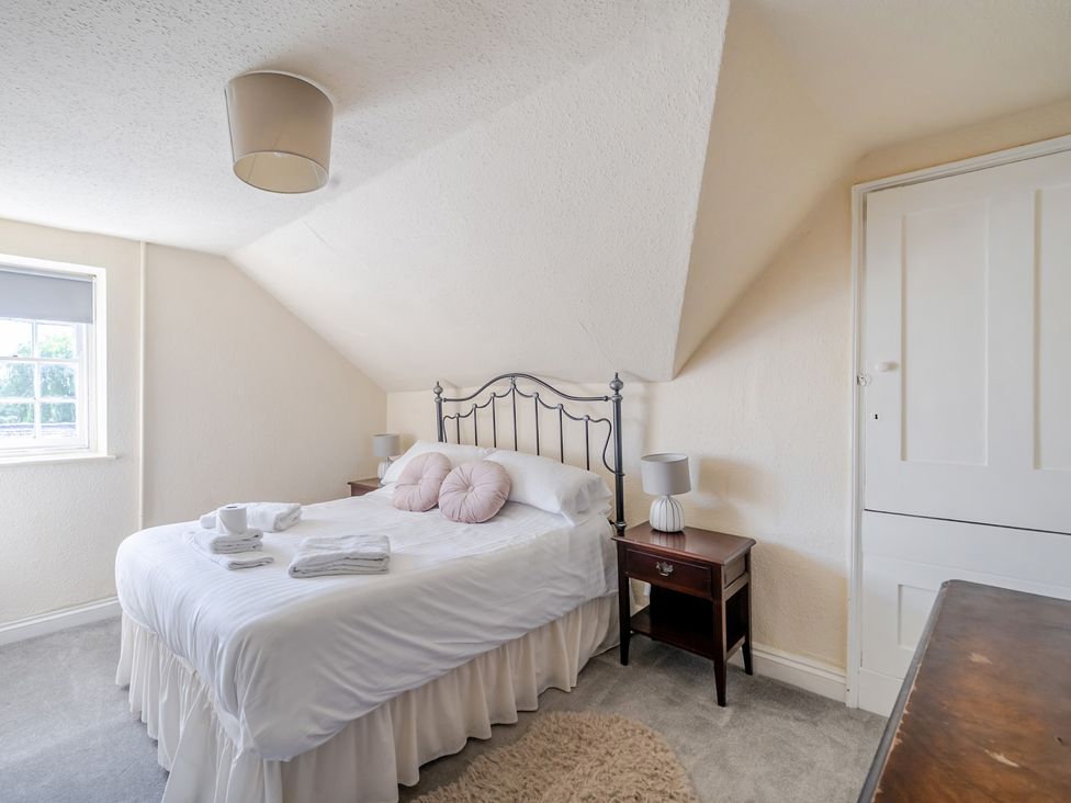 A bedroom with a bed and bedside table at Milton Manor in Milton On Stour