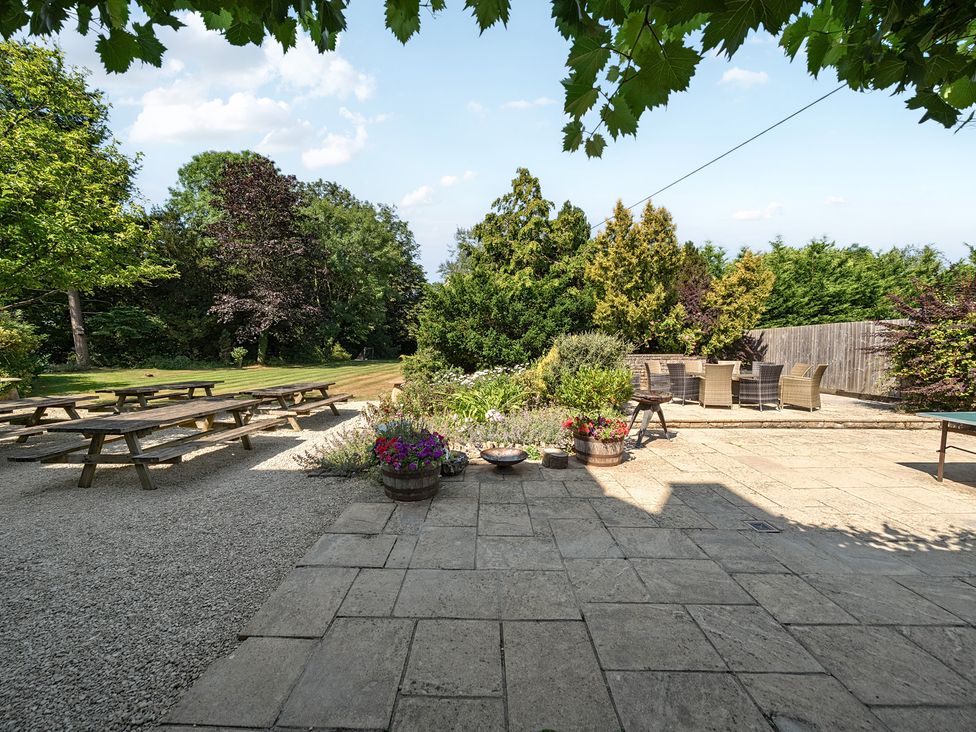A garden with seating and flower pots at Milton Manor in Milton On Stour