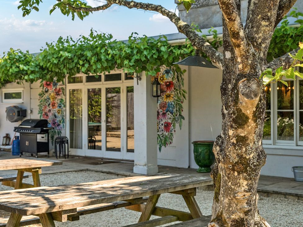 An outdoor area with tables and a grill at Milton Manor Milton On Stour