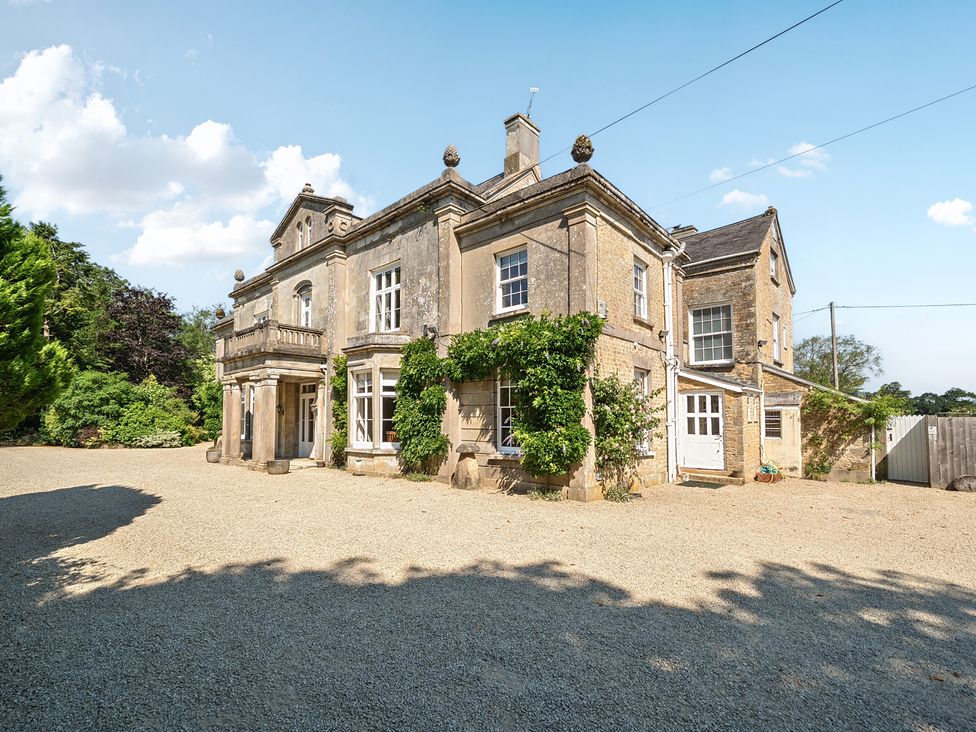 An exterior view of a house with windows and door at Milton Manor in Milton On Stour