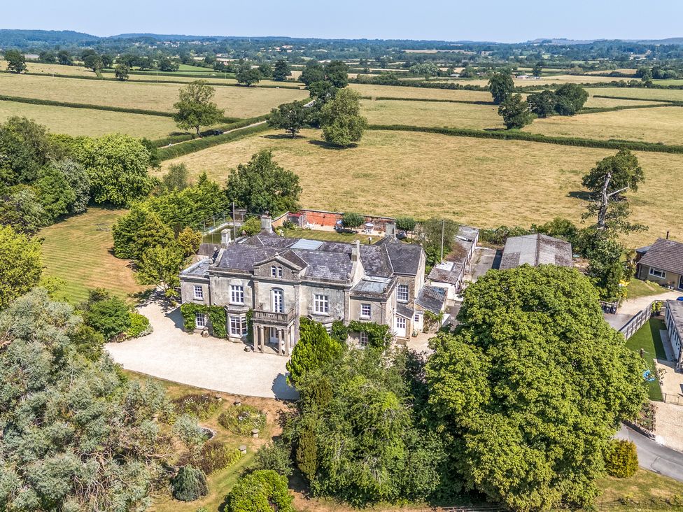 An aerial view of a house surrounded by fields at Milton Manor in Milton On Stour