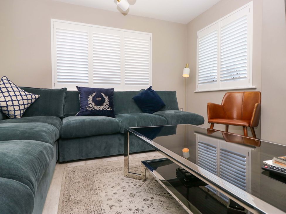 A living room with a sofa, coffee table, and window at Bishop Fell in Newby Bridge
