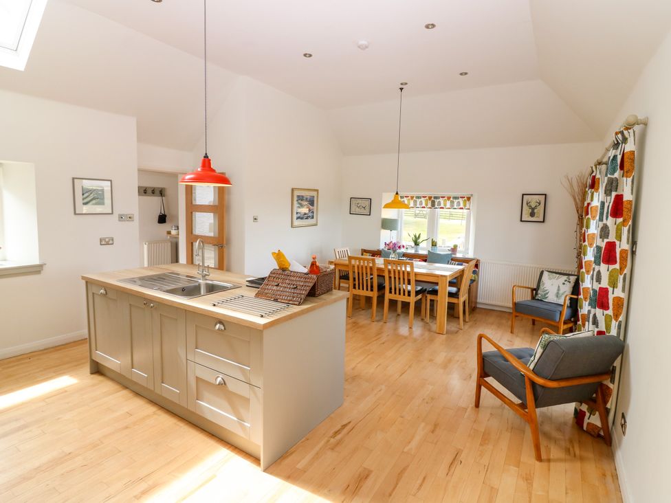 A kitchen with dining area and island at Whitehouse Woodwrae Aberlemno near Forfar