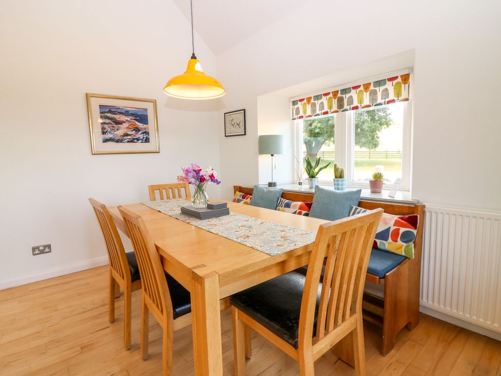 A dining room with a wooden table and chairs at Whitehouse Woodwrae Aberlemno near Forfar