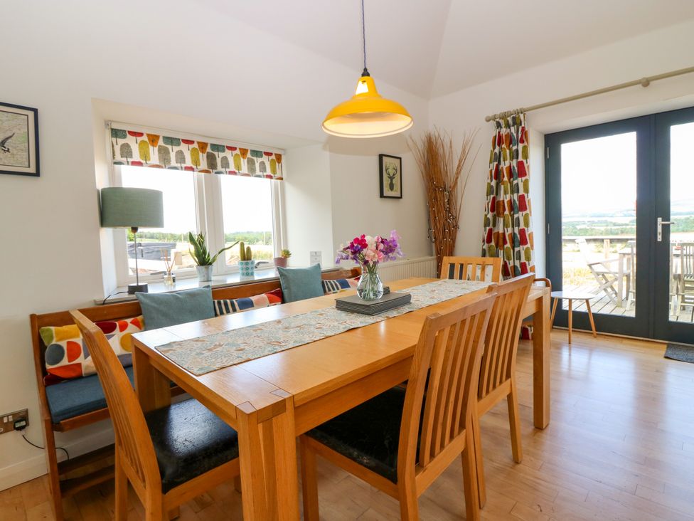 A dining room featuring a table with chairs and a view at Whitehouse Woodwrae Aberlemno near Forfar