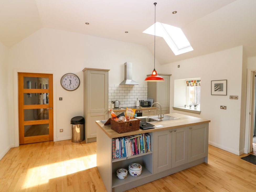 A kitchen with an island and sink at Whitehouse Woodwrae Aberlemno near Forfar