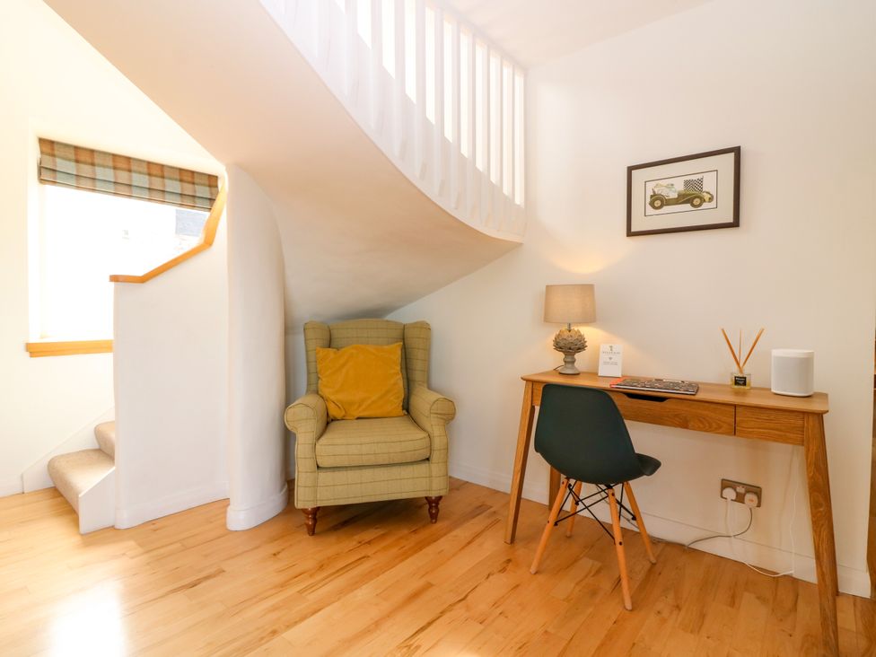 A study area with a desk and armchair at Whitehouse Woodwrae Aberlemno near Forfar
