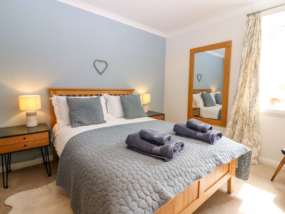 A bedroom with a bed and bedside tables at Whitehouse Woodwrae Aberlemno near Forfar