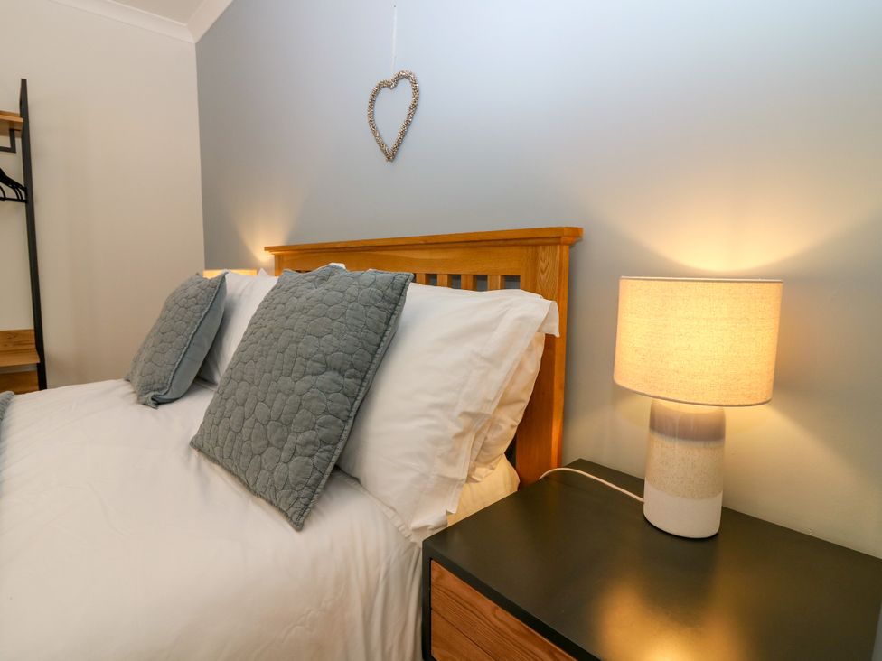 A bedroom with a bed and lamp at Whitehouse Woodwrae Aberlemno near Forfar
