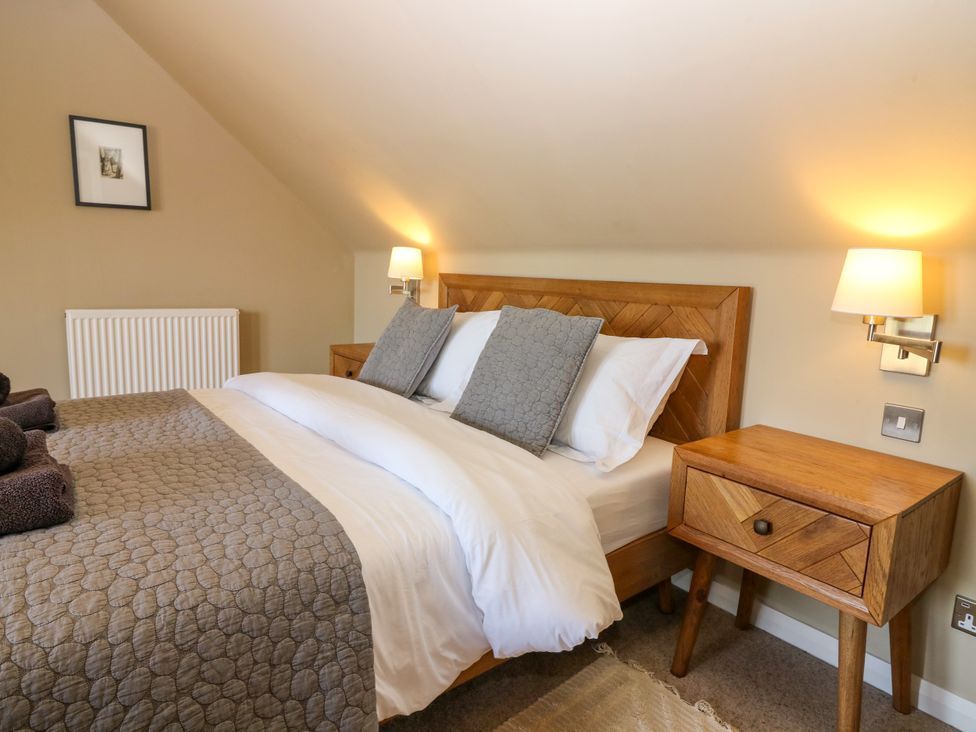 A bedroom with a bed and bedside table at Whitehouse Woodwrae Aberlemno near Forfar