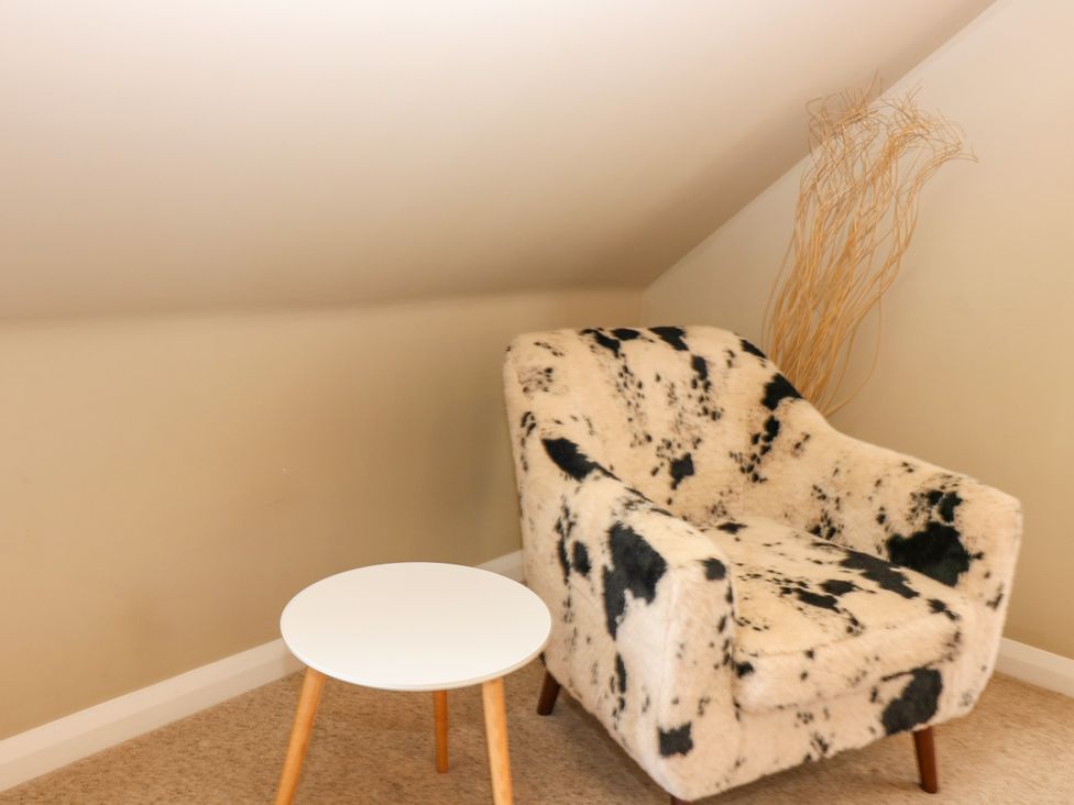 An armchair and side table in an attic at Whitehouse Woodwrae Aberlemno near Forfar
