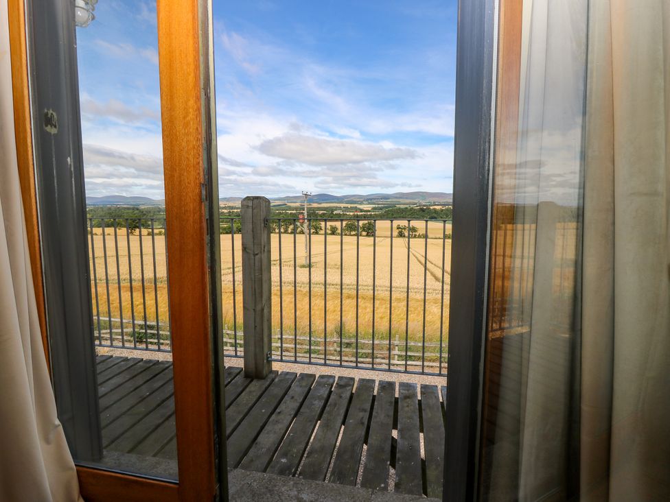 A view from a balcony showing fields and mountains at Whitehouse Woodwrae Aberlemno near Forfar