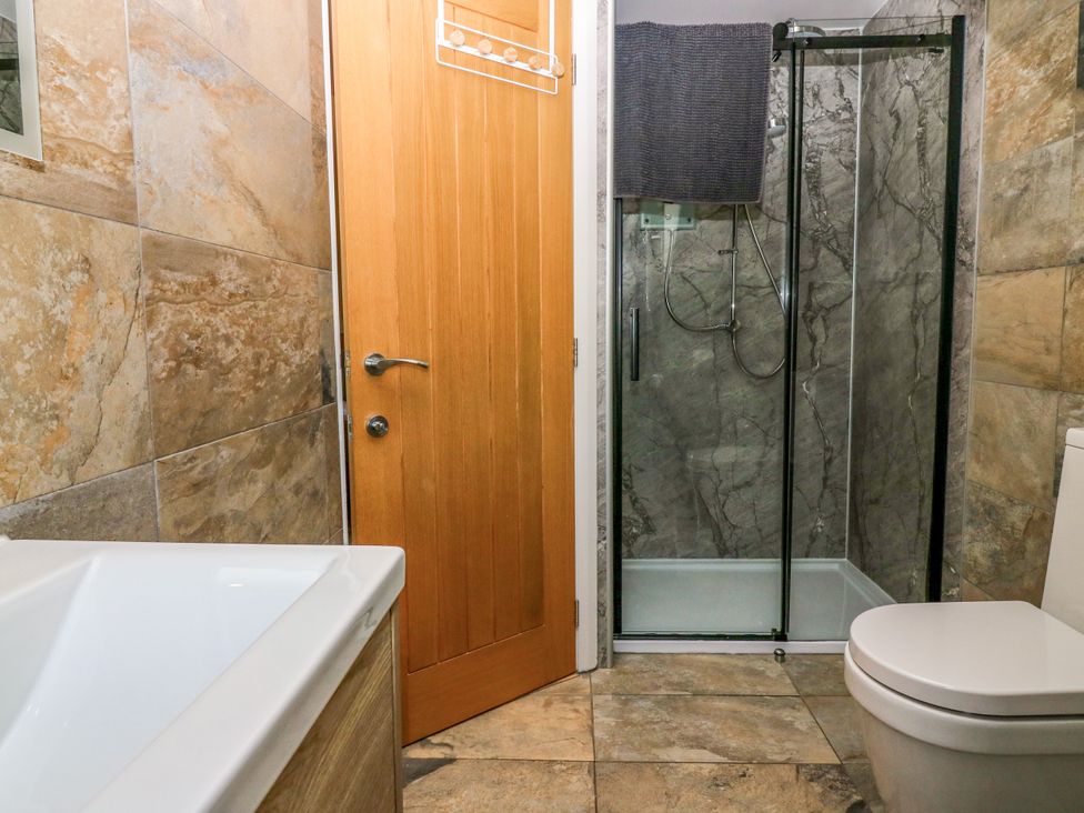 A bathroom with a shower and a toilet at Whitehouse Woodwrae Aberlemno near Forfar