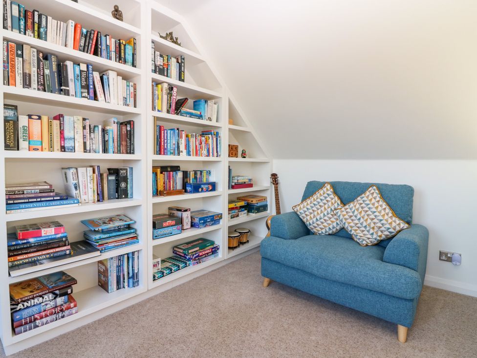 A study with a bookshelf and a sofa at Whitehouse Woodwrae Aberlemno near Forfar