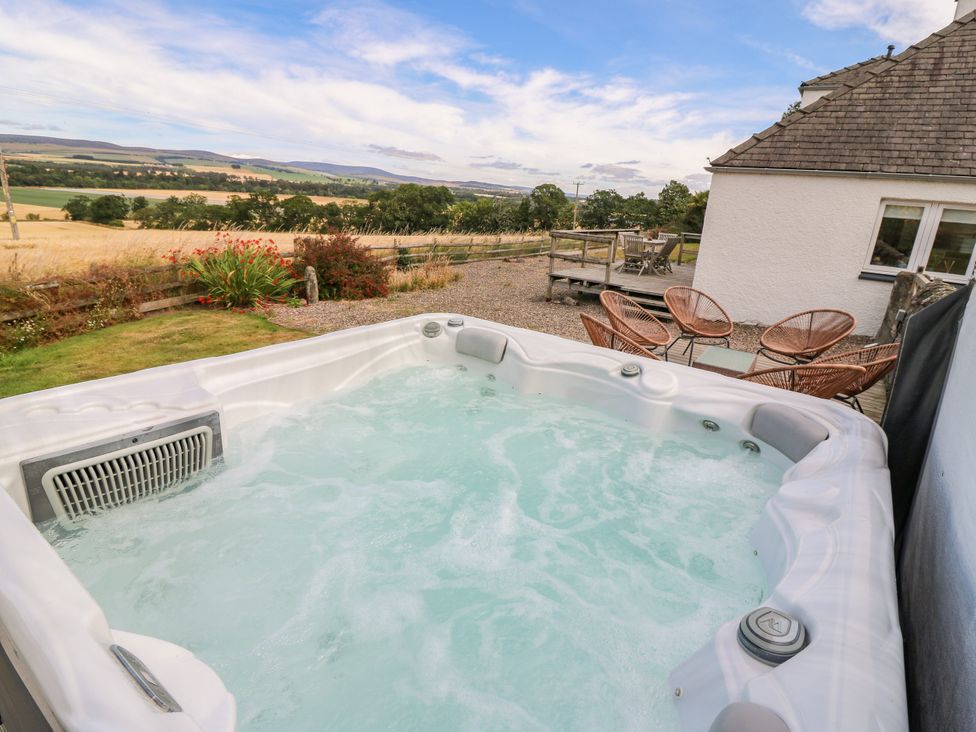 A hot tub with deck chairs and a view at Whitehouse Woodwrae Aberlemno near Forfar