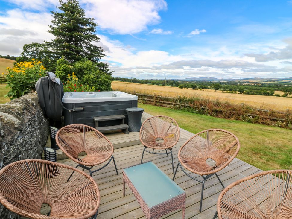 An outdoor area with chairs and a hot tub at Whitehouse Woodwrae Aberlemno near Forfar