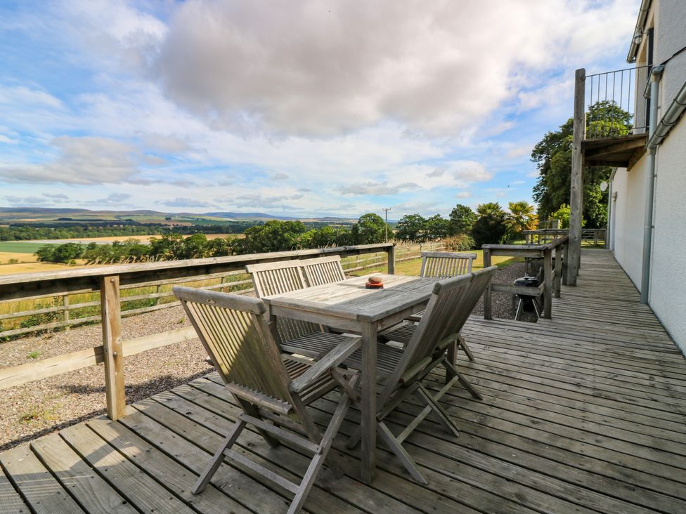 An outdoor deck with seating and a view at Whitehouse Woodwrae Aberlemno near Forfar