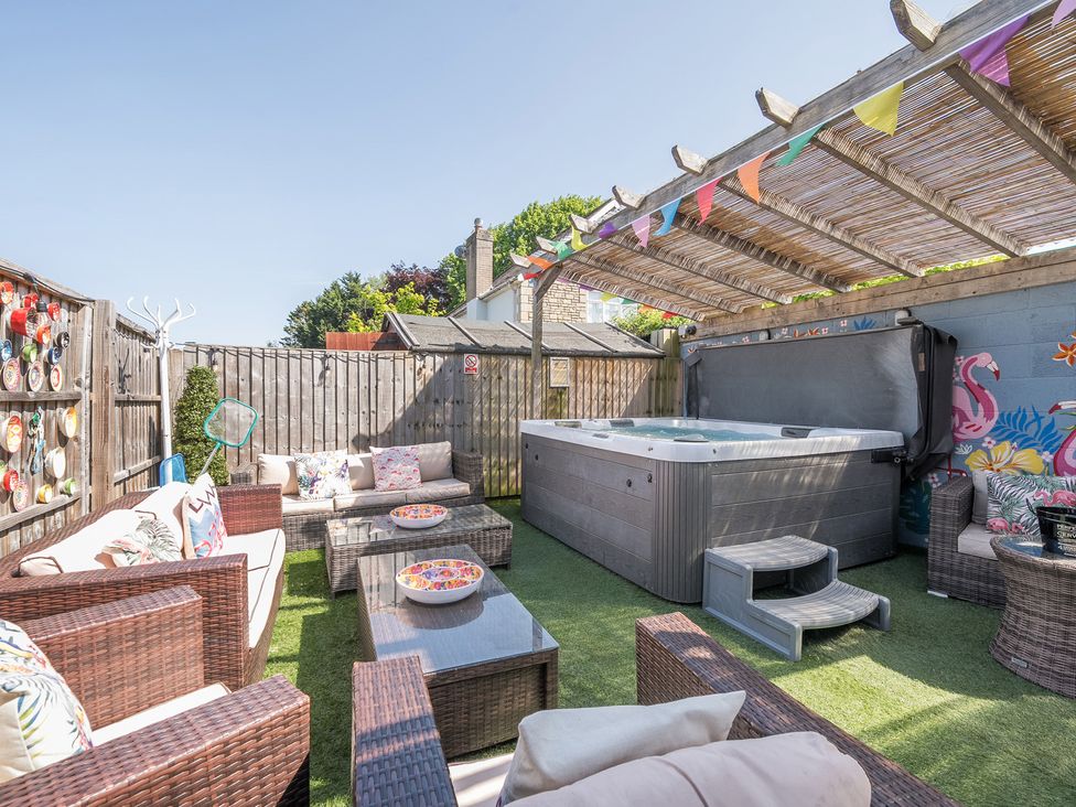 A garden with outdoor seating and a hot tub at The Boars Head Pub in Bishop's Castle