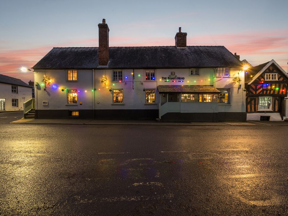 A pub exterior with lights at The Boars Head Pub in Bishop's Castle