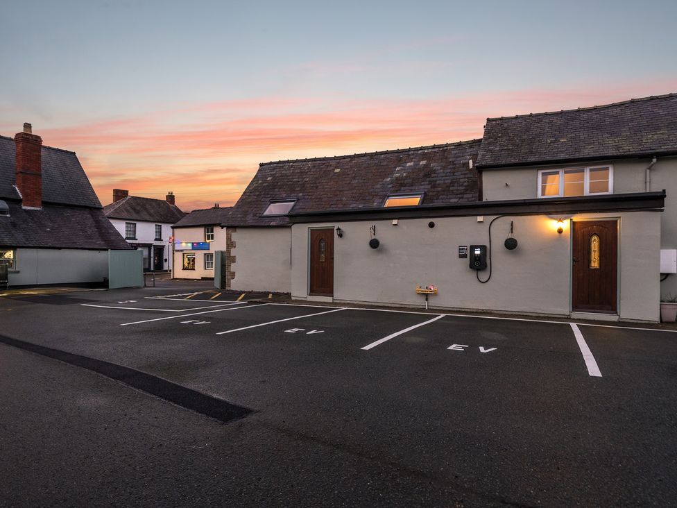 An outdoor area with buildings and parking spaces at The Boars Head Pub in Bishop's Castle