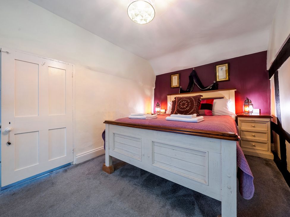 A bedroom with a bed and bedside tables at The Boars Head Pub in Bishop's Castle