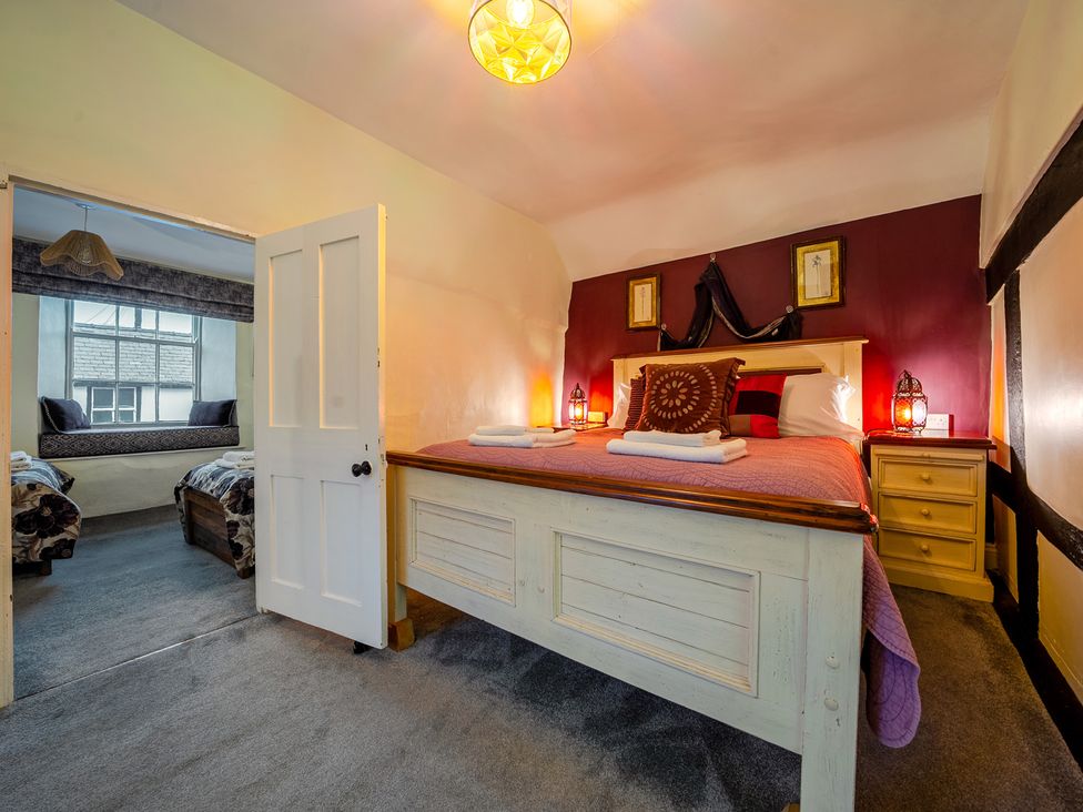 A bedroom with a bed and a view of another room at The Boars Head Pub in Bishop's Castle