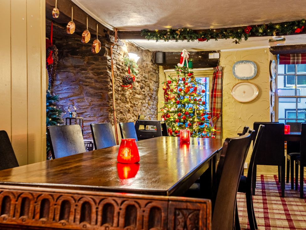 A dining room with a table and Christmas decorations at The Boars Head Pub in Bishop's Castle
