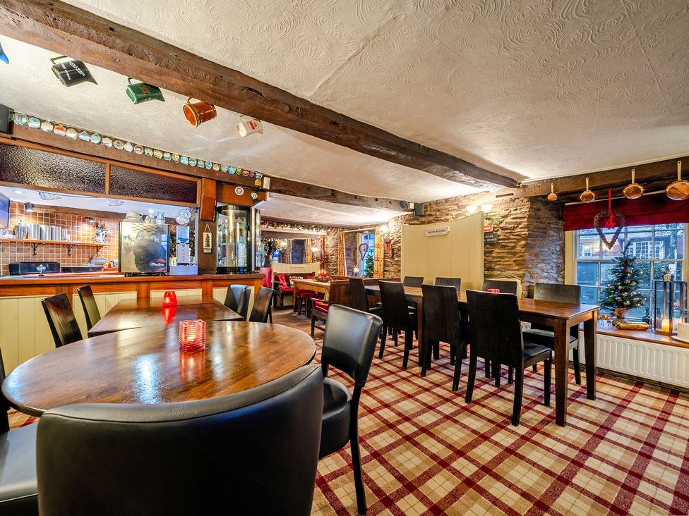 A dining room with tables and chairs at The Boars Head Pub in Bishop's Castle