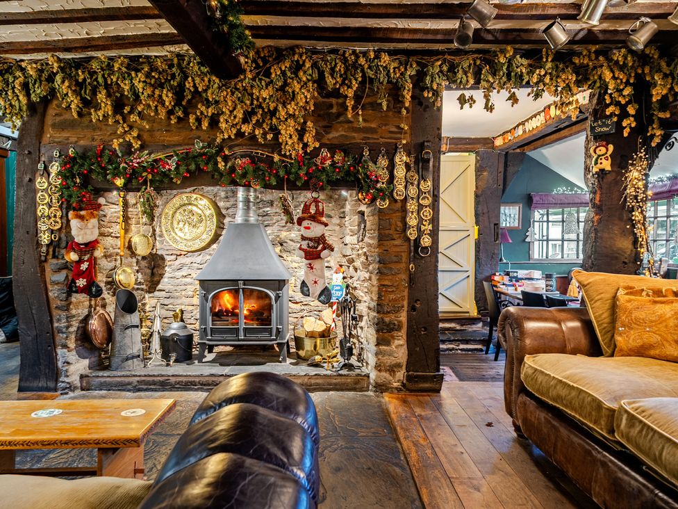 A living room with a fireplace and a sofa at The Boars Head Pub in Bishop's Castle