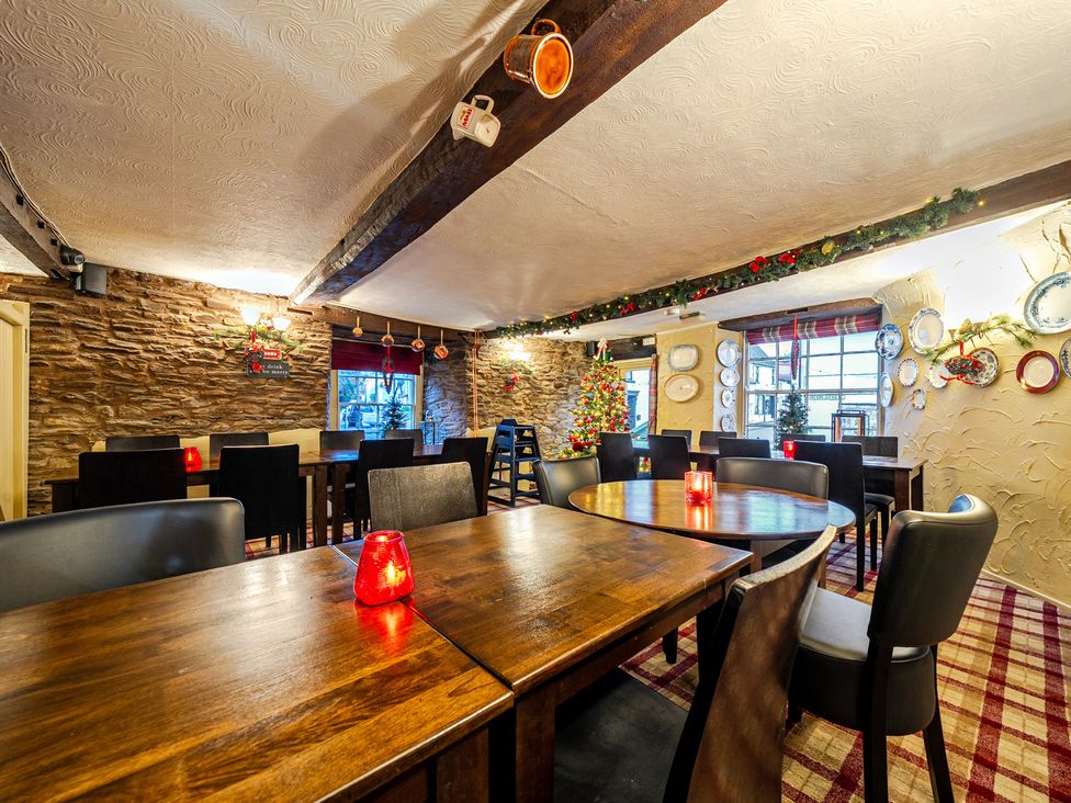 A dining room with tables and chairs at The Boars Head Pub in Bishop's Castle