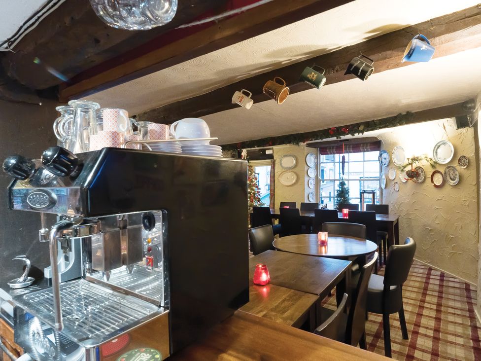 A dining room with tables and an espresso machine at The Boars Head Pub in Bishop's Castle