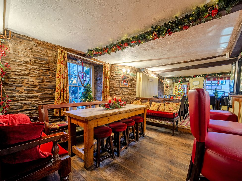 A pub with wooden furniture and festive decorations at The Boars Head Pub in Bishop's Castle
