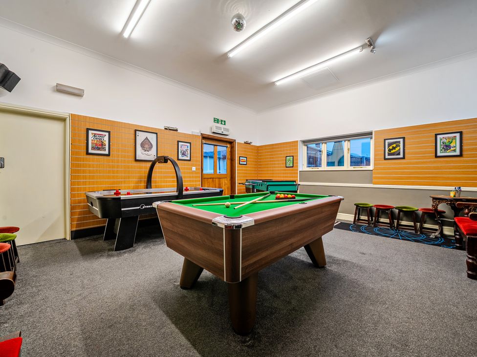 A game room with a pool table and air hockey table at The Boars Head Pub in Bishop's Castle